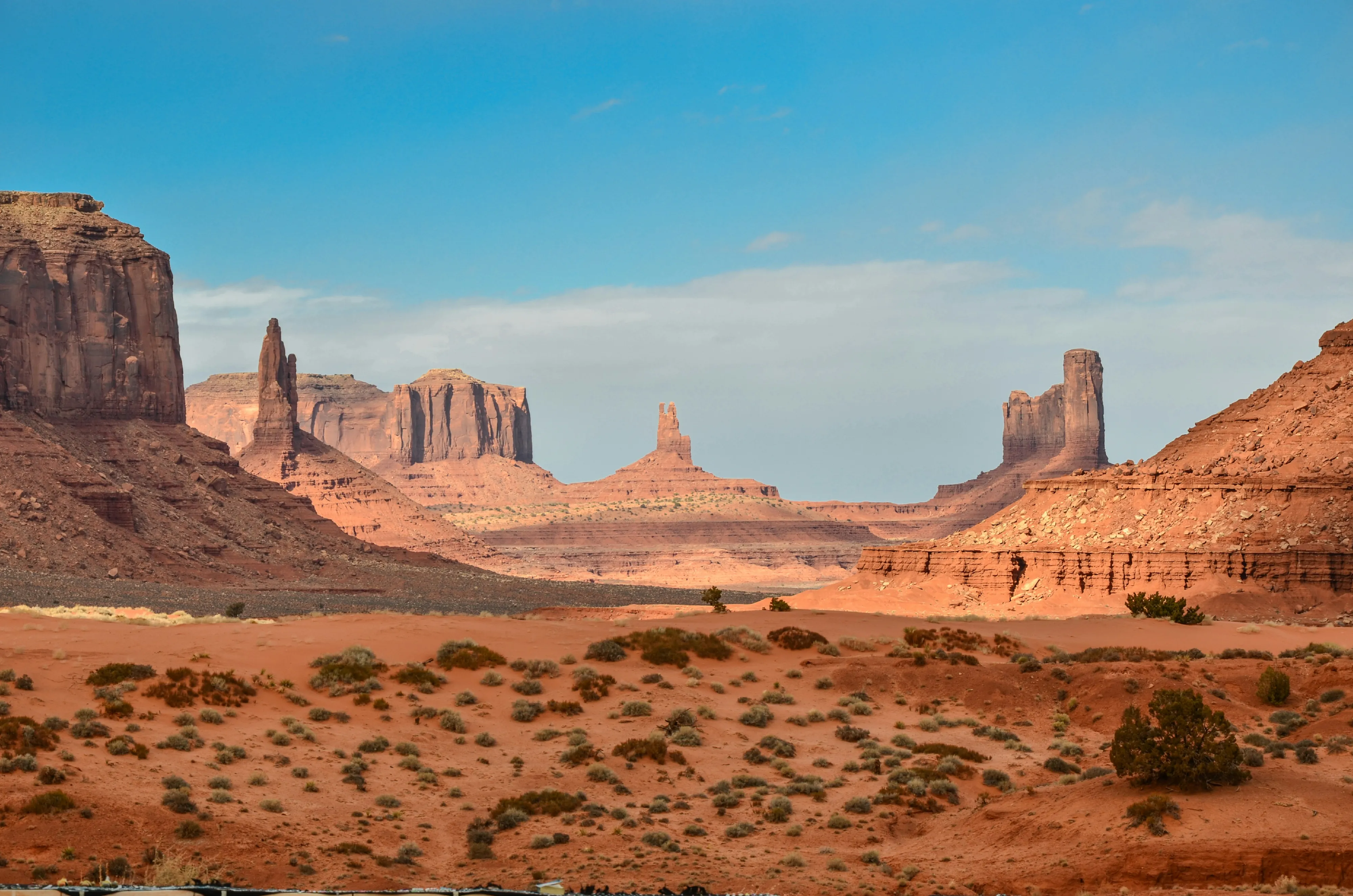 Ancient Afro-fantasy caravan crossing luminous desert flats beneath enormous moons.